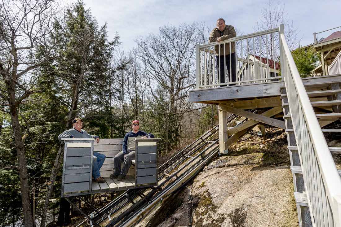 Cottage lifts elevation solutions team on a deck overlooking lake